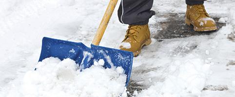 Adult shoveling snow in boots | CNA Canada