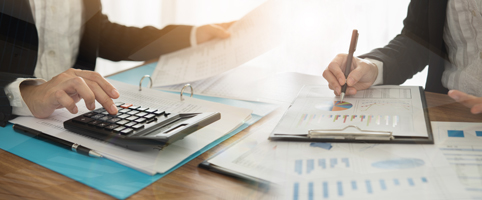 Professionals conducting analysis at conference room table l CNA Insurance