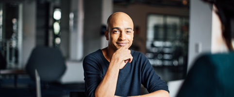 Team discussing over laptop in office at night | CNA Insurance