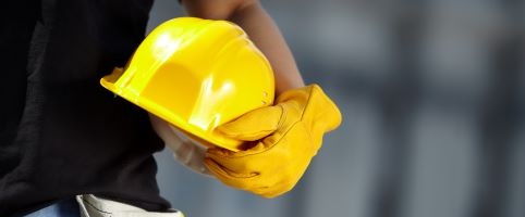 Construction worker holding hard hat | CNA Canada