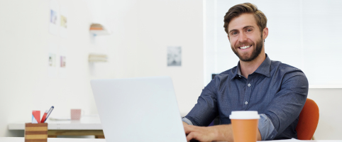 Cropped portrait of a young businessman using his laptop in the office