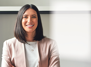 Woman standing in an office with arms crossed