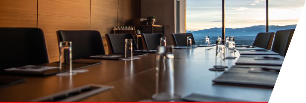 View of people gathered around a table in conversation | CNA Insurance
