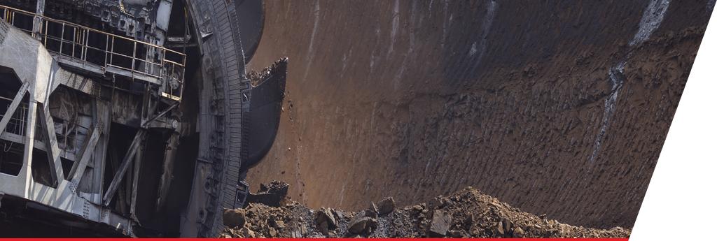 Rock excavator moving through a mine | CNA Insurance