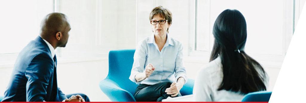 Three professionals seated in discussion | CNA Insurance