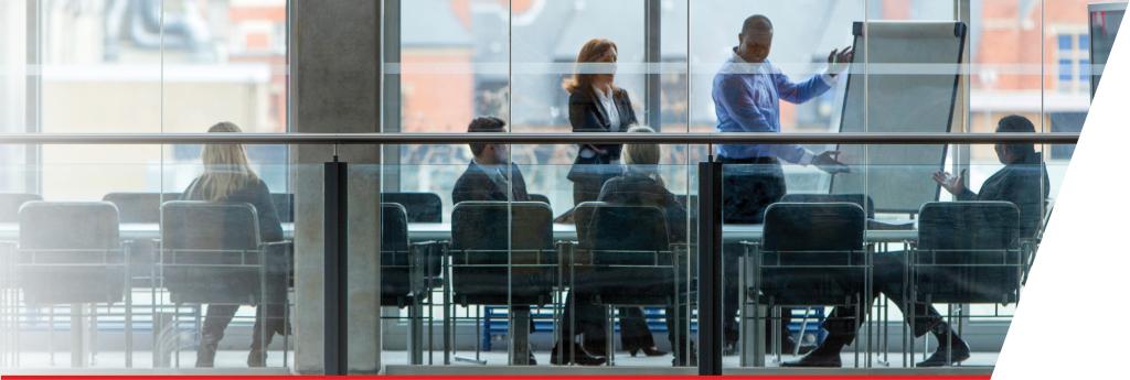 Team collaborating in glass conference room | CNA Canada