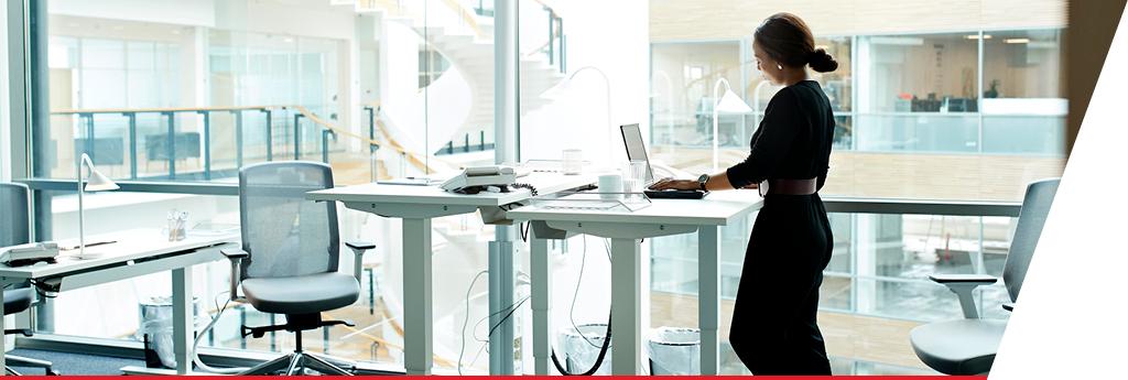 Woman working at a standing desk in an office