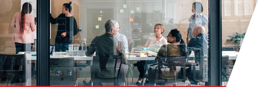 Professionals conducting analysis at conference room table
