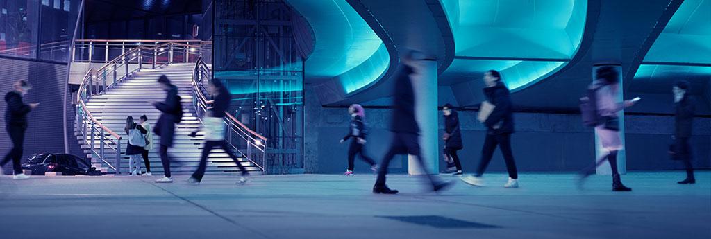 People walking through an office building