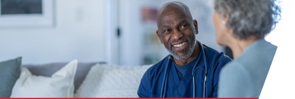 Nurse sitting with patient on a couch