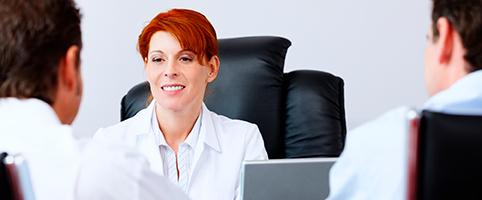 Woman with red hair at desk.