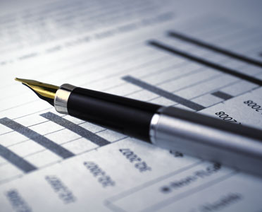 Pen resting on financial document | CNA Insurance